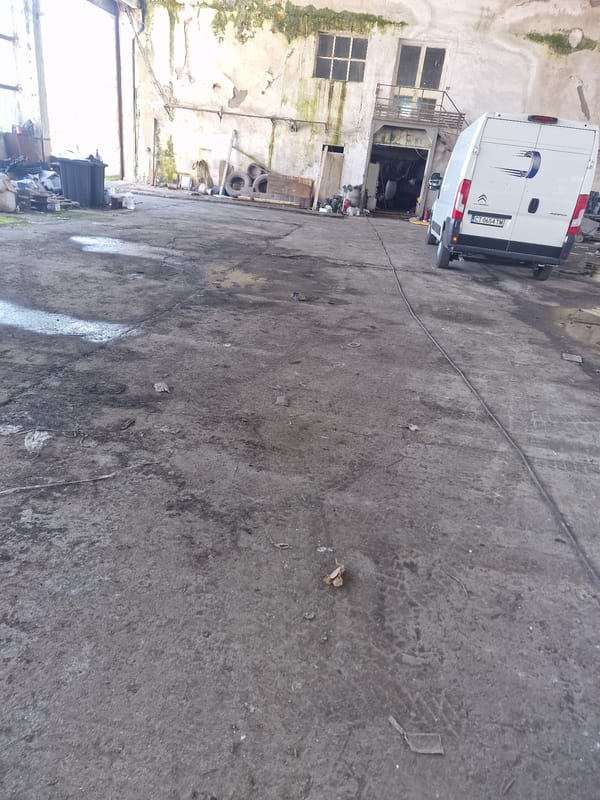 White van with Connecticut plates parked in concrete area