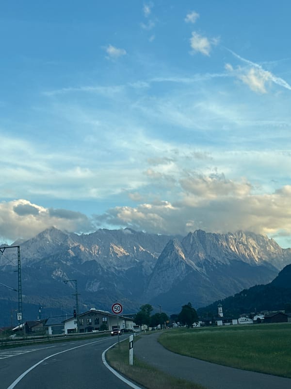 Alpine road through Farchant with mountain views behind the village