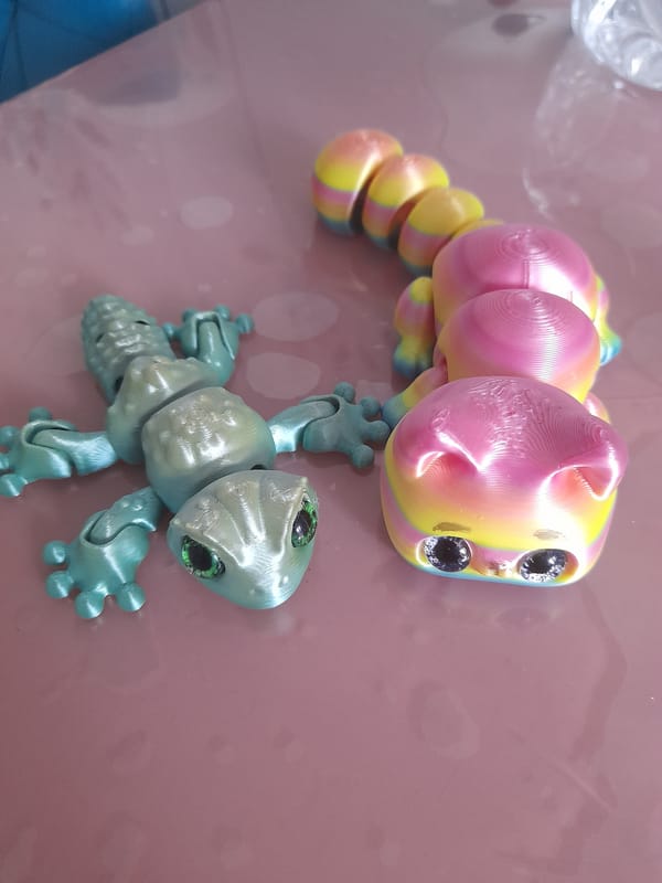 Person showcases colorful 3D-printed articulated toy collection