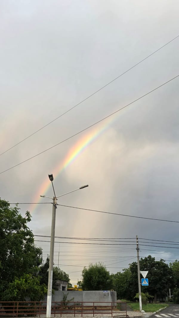 Rainbow over Izmail's cloudy skies, framed by power lines
