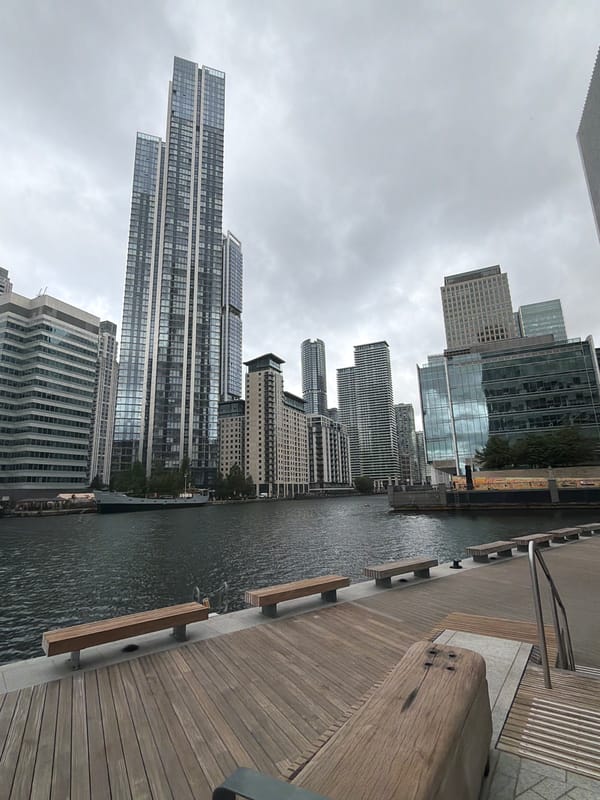London waterfront morning walk captures luxury yacht, modern skyline