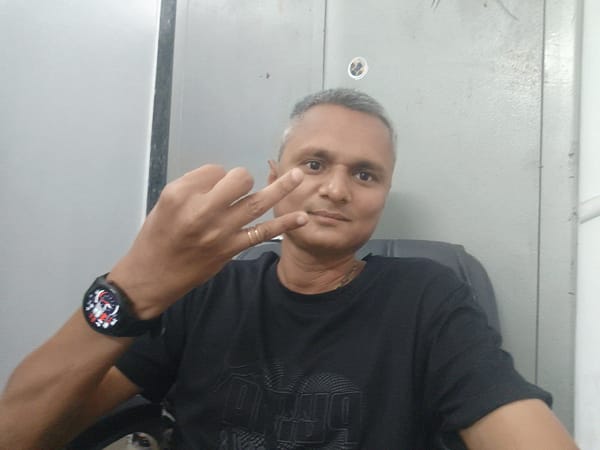 Man Makes Hand Gestures in Office Chair, Dhandhuka