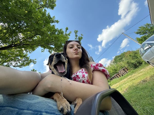 Woman relaxes with dog during outdoor afternoon in Bulgaria