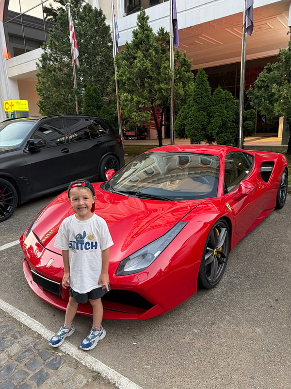 Posing next to a red Ferrari in Batumi, Georgia