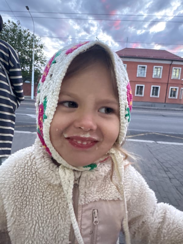 Child and residential building photographed in Kaliningrad evening