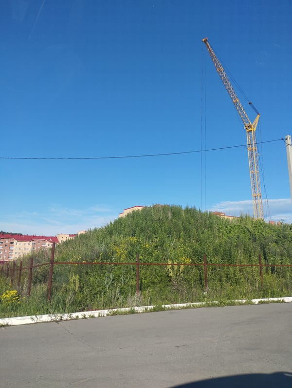 Quick drive past apartments, a parking lot, and a construction crane