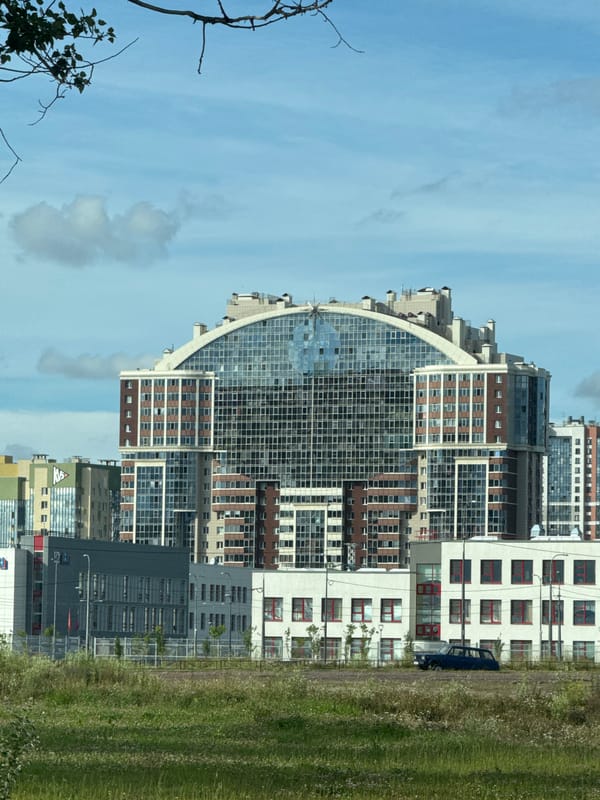 Curved glass residential tower in a new Saint Petersburg development