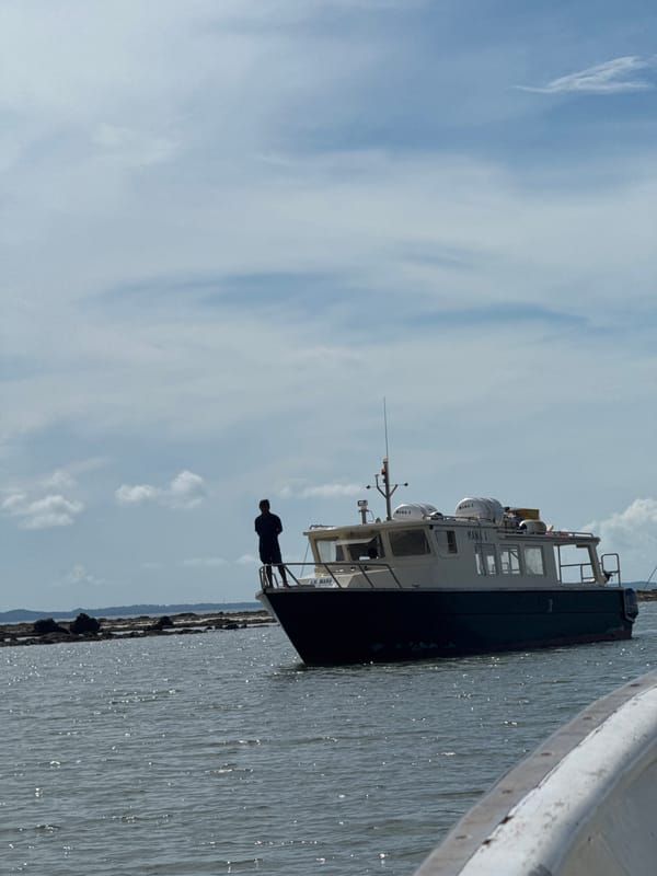 Boats and crew at Teluk Bakau harbor, Indonesian coast