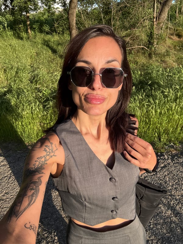 Tattooed woman in gray vest spotted outdoors, elevator in Pleven