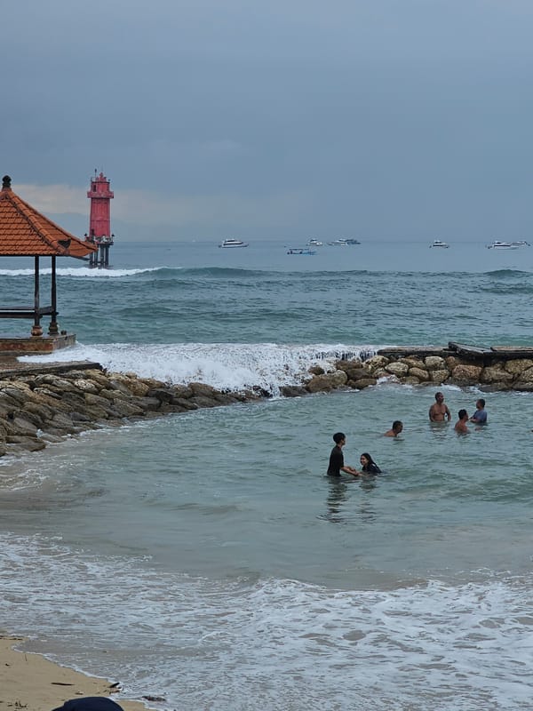 Temple visitors and boats observed at Denpasar coastline