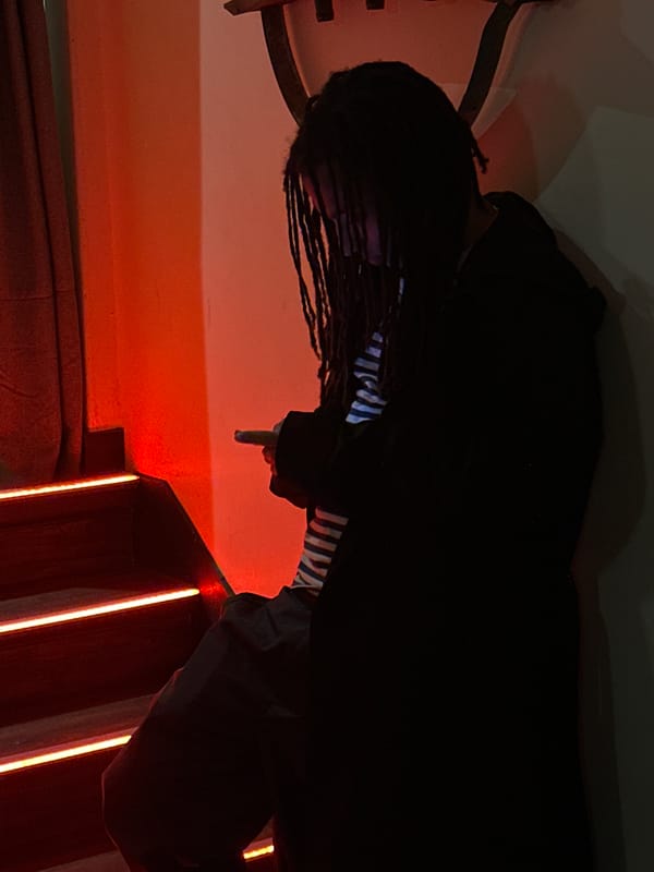 Woman poses at Paris bar entrance Friday night