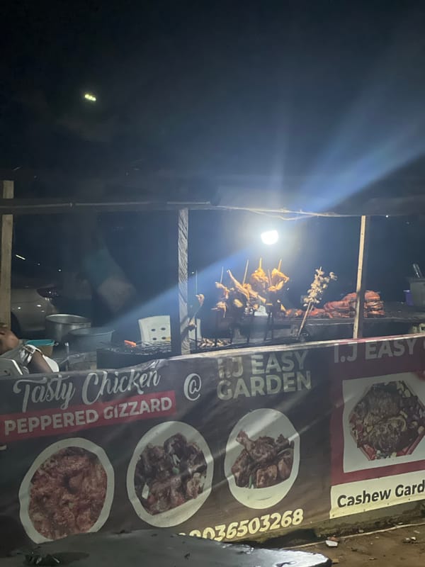 Street food vendor prepares grilled chicken sandwiches in Abuja