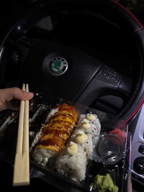 Driver eats sushi with chopsticks in Skoda car