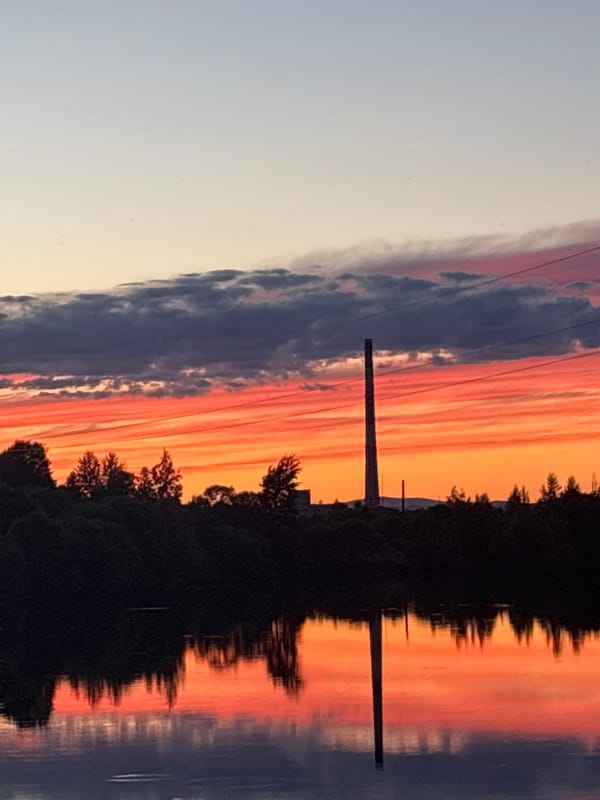 Sunset over Birobidzhan with parked car and power infrastructure