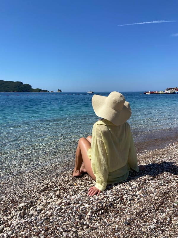 Person enjoys morning moment on Budva beach