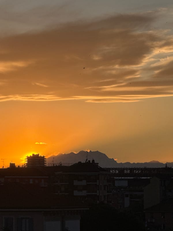 Golden sunset observed over Milan from elevated viewpoint