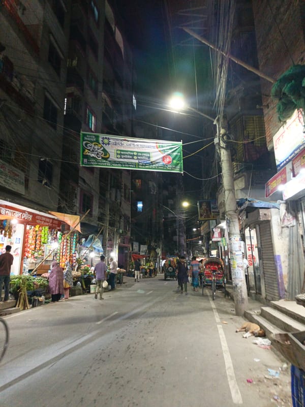 Evening street food vendor operates in downtown Dhaka