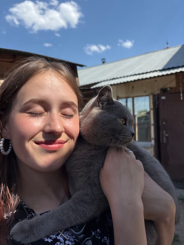 Woman enjoys peaceful moment with gray cat in Russia