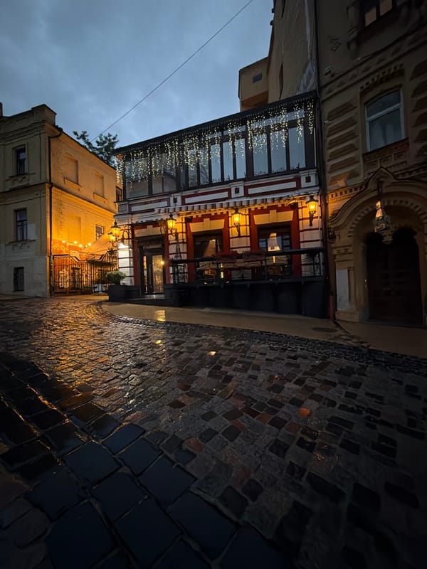 Evening stroll through rainy Kyiv captures church, cafes, wet streets