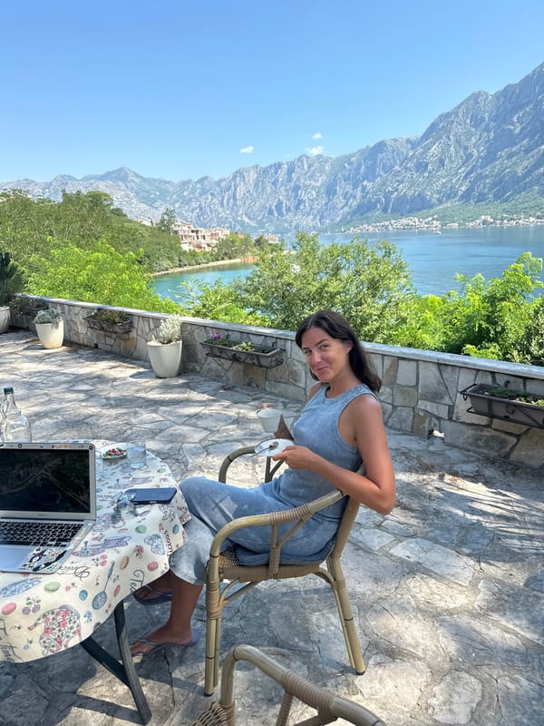 Laptop and coffee on a floral tablecloth in coastal Montenegro