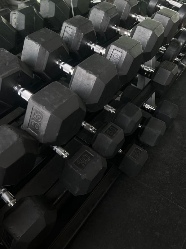 Mexico City gym displays organized heavy dumbbell rack
