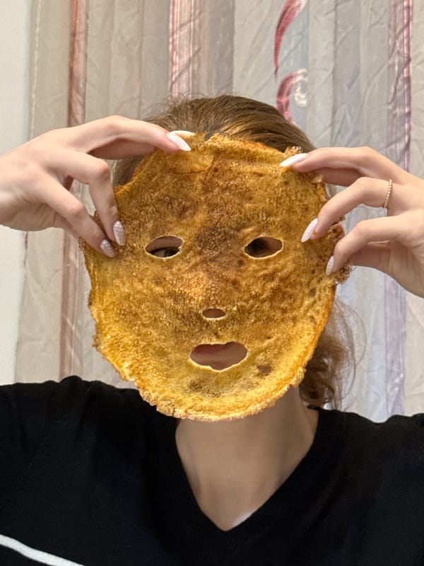 Woman uses holey pancake as playful face mask in Serbia