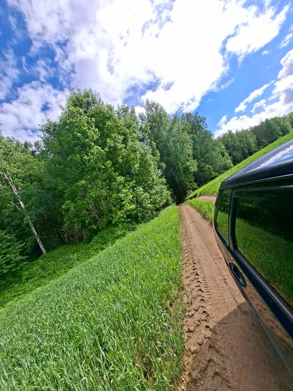 Vehicle travels rural roads through Karsha countryside forests