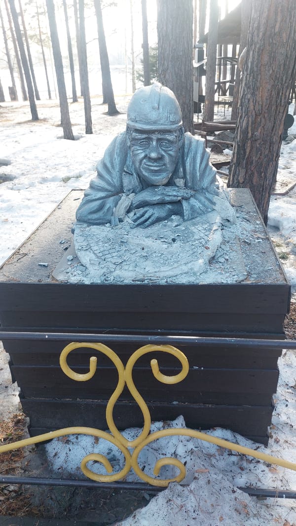 Children play in snowy Novosibirsk park with monuments