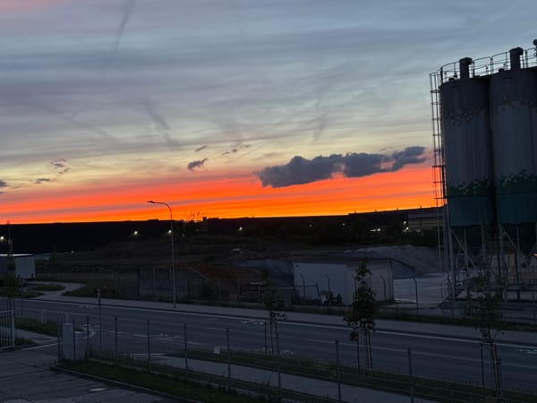Dramatic sunset illuminates industrial landscape in Pilsen, Czechia