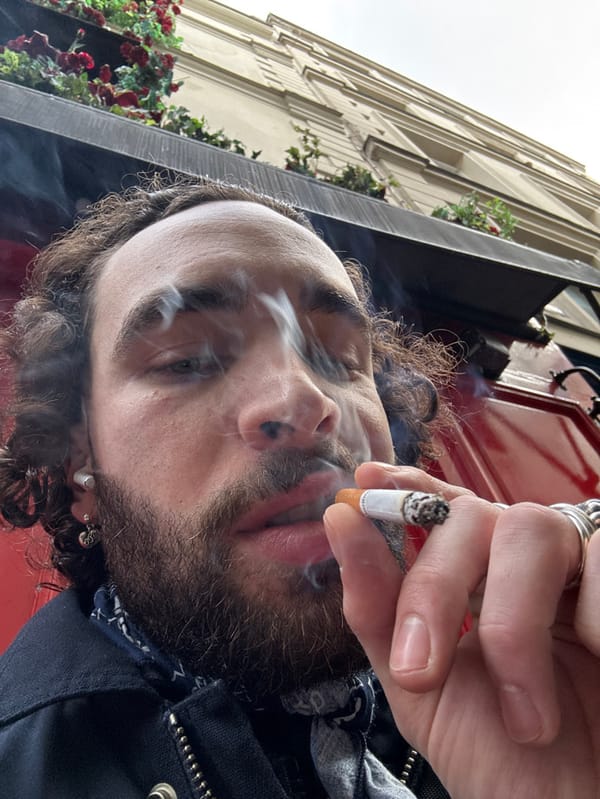 Man photographed smoking near red door in Paris