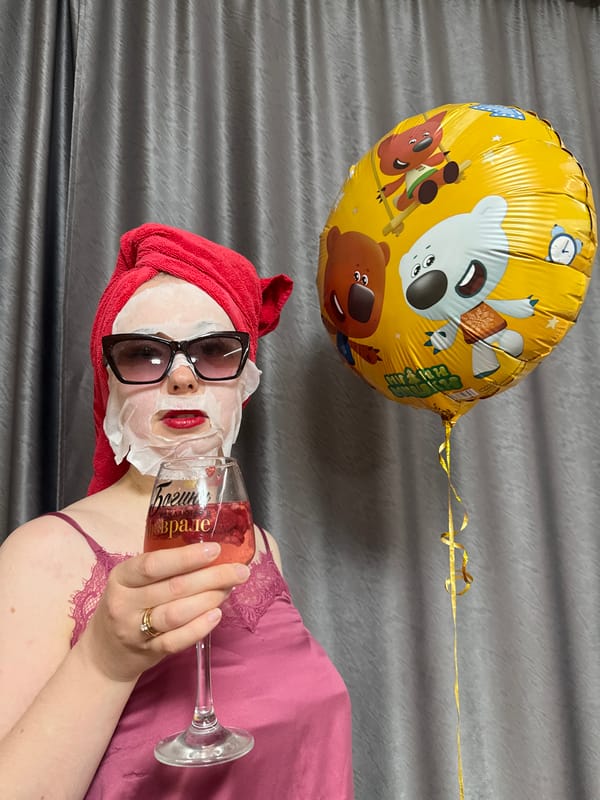 Person enjoys spa day with wine, balloon, heart drawings