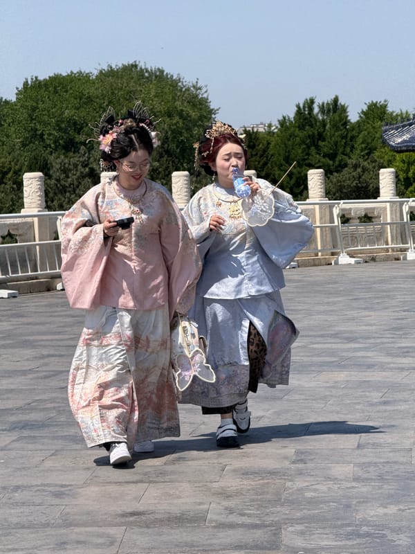 Two people in traditional dress spotted on Beijing walkway