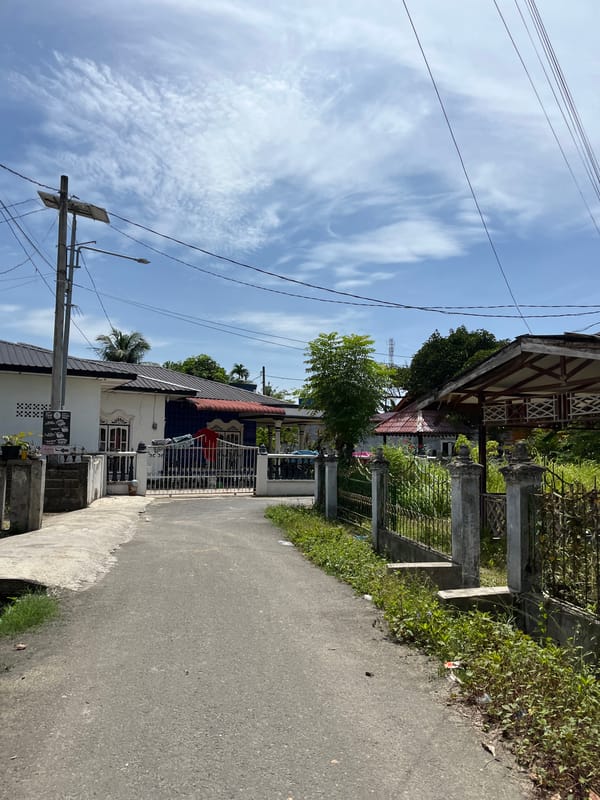 Cruising through Langsa's quiet residential streets on a sunny morning
