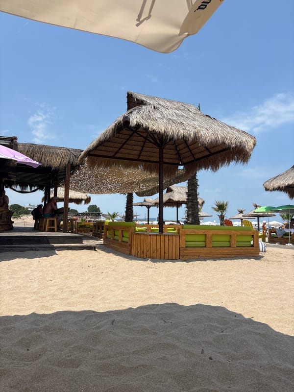 Sunny beach with a striking shadow across the sand