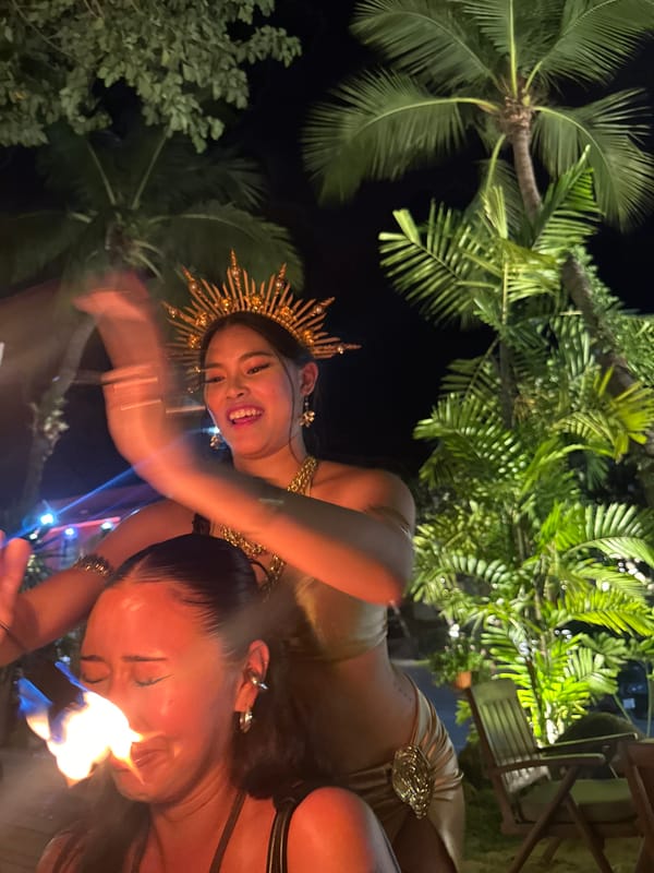 Women perform evening show in golden costumes, Baan Chaweng