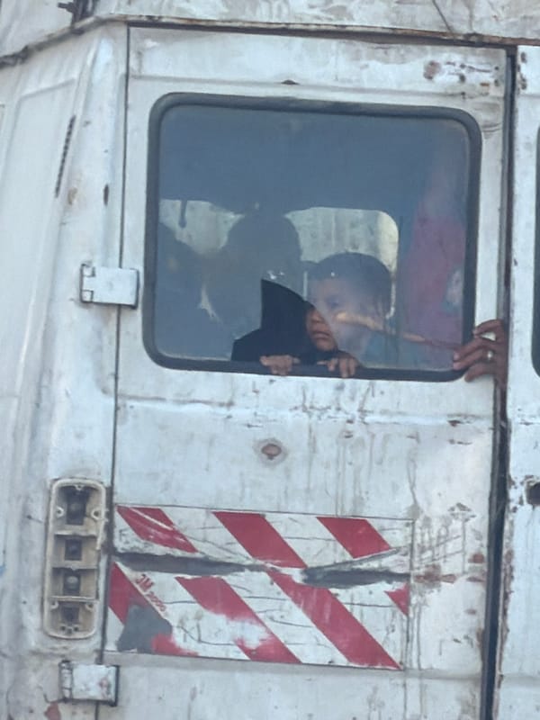 Person seen in window of worn truck in Gaza