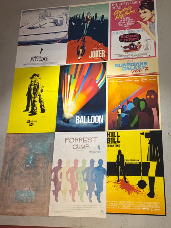 Person arranges movie posters, drinks Lipton tea in Saint Petersburg