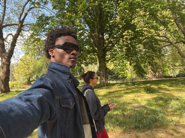 Two people walk in sunny London park