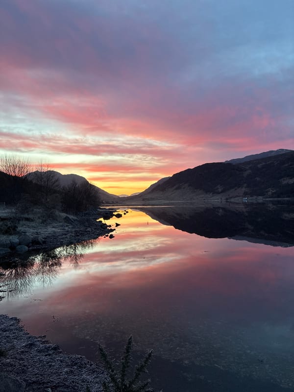 Colorful sunrise captured over Scottish loch in Strontian