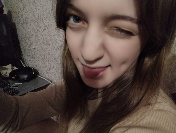 Woman captures playful winking selfie with tongue out