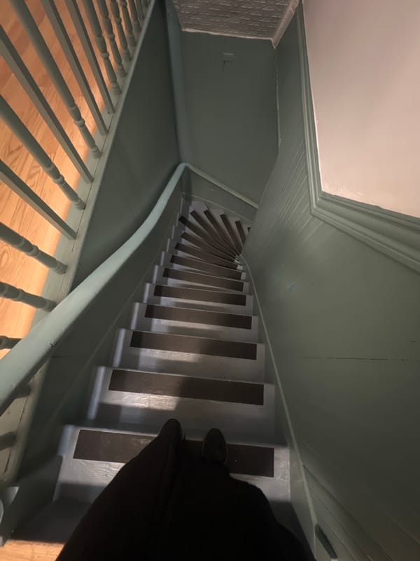 Interior staircase with green walls photographed in New York