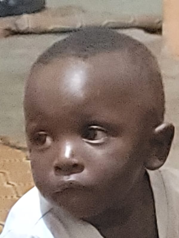 Evening life documented in Nigerian village: child, rabbit, roasted corn