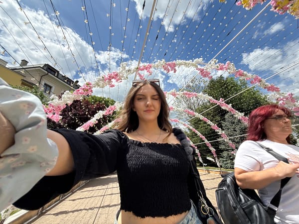 Woman poses near floral tunnel display in Sliven