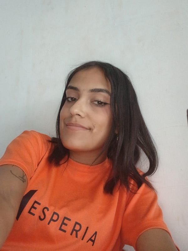 Person in orange ESPERIA shirt photographed at Playa El Agua