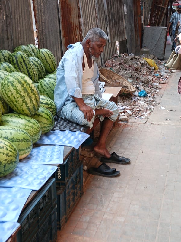 Street vendors sell fresh produce and flowers in Dhaka
