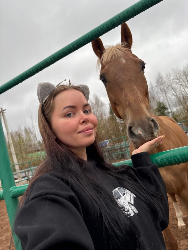 Woman in cat ears interacts with horse in Russia