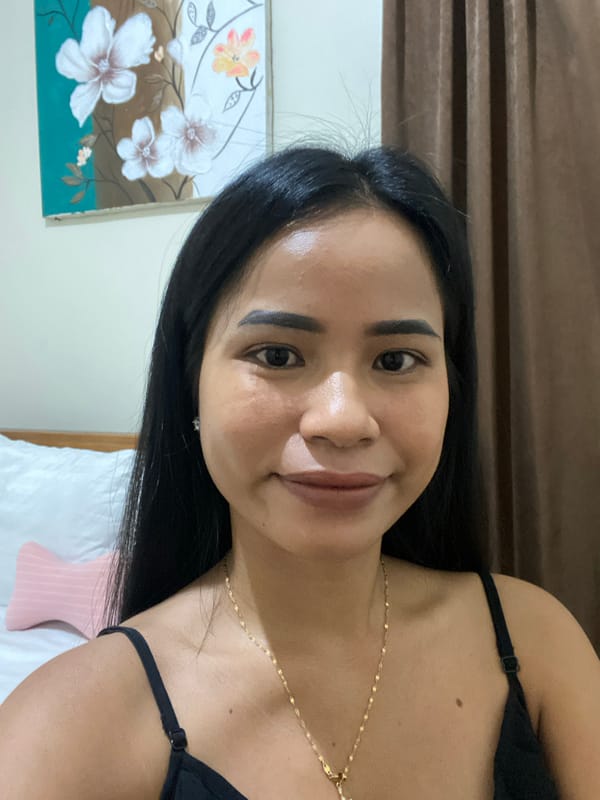 Woman photographed smiling indoors in North Kuta, Indonesia