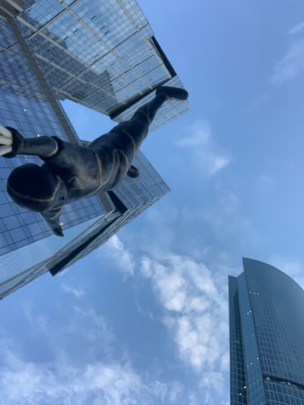 Handstand statue photographed against skyscrapers in Khimki, Russia