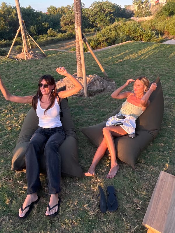 Sunset hangout on a grassy Bali hillside overlooking the ocean