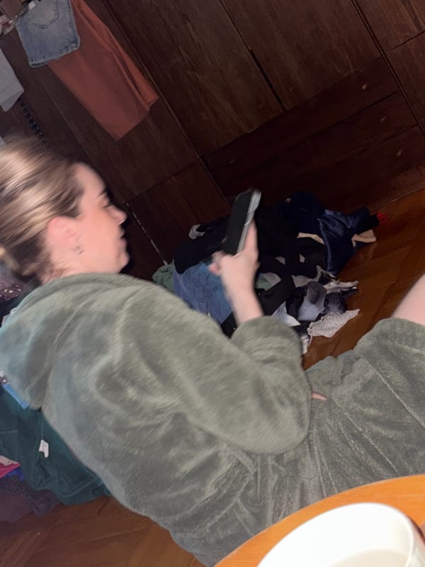 Woman relaxing at home with phone in Sinyavino
